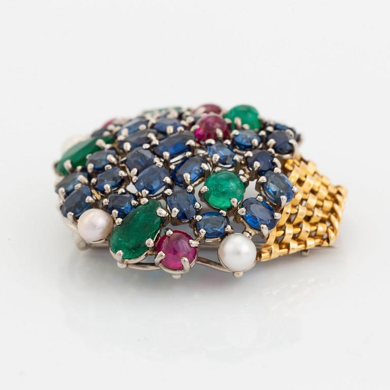 An 18K gold Carlman brooch set with sapphires, emeralds, rubies and pearls.