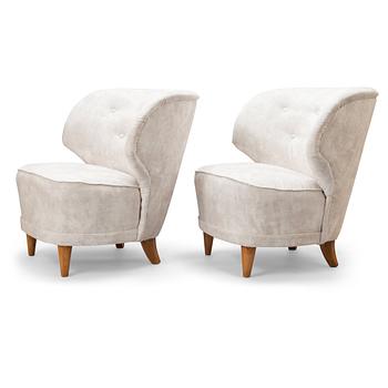 A pair of mid-20th-century armchairs.