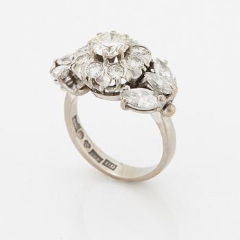 An 18K white gold ring set with round brilliant- and navette-cut diamonds.