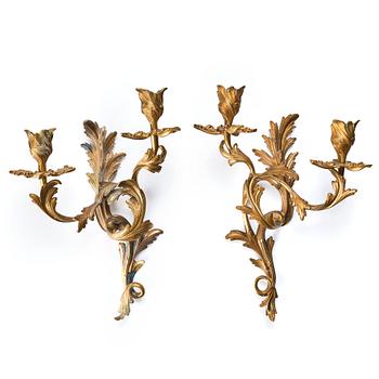 119. A pair of Rococo 18th century gilt bronze two light wall-lights.