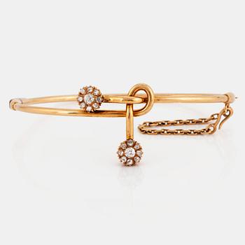 A 14K gold bangle set with old- and rose-cut diamonds.