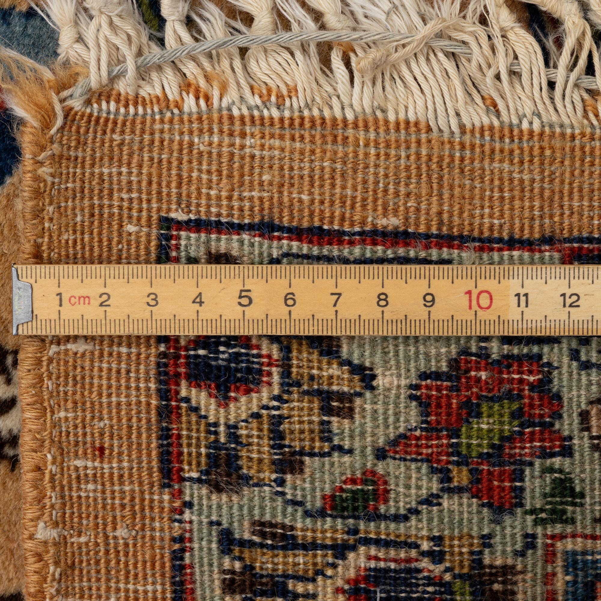 A semi-antique Tabriz carpet of vase design, West Persia, c. 404 x 292 cm.