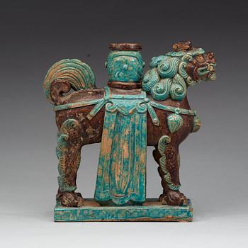 A turkoise and aubergine glazed figure of a Mythical beast, late Ming dynasty (1368-1644).