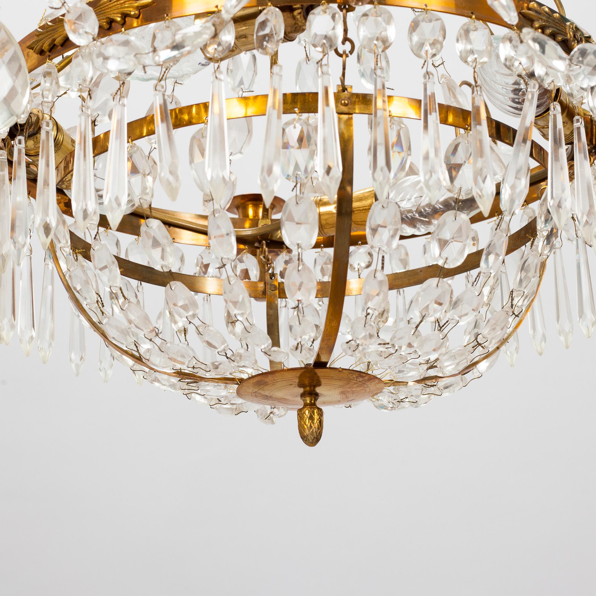 A Gustavian style chandelier from the first half of the 20th century. Height 67 cm.