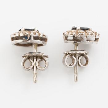 Earrings, a pair of 18K white gold set with dark sapphires and small brilliant-cut diamonds.