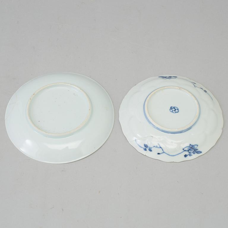 Two blue and white dishes and two cups with dishes, Qing dynasty, Qianlong (1736-95) and Kangxi (1662-1722).