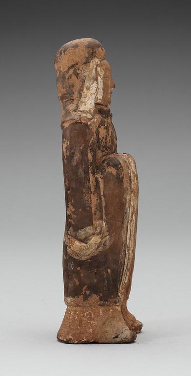 A painted pottery figure of a standing female, Tang dynasty (618-907).
