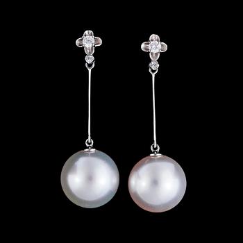 1131. A pair of cultured South sea pearl, 13 mm, and brilliant cut diamonds, tot. app. 0.16 cts.