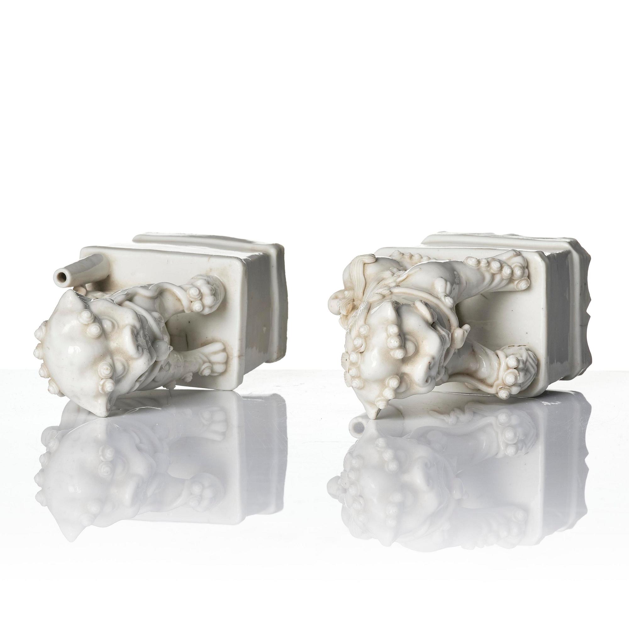 Two blanc de chine figures of buddhist lions/joss stick holders, Qing dynasty, Kangxi (1662-1722).