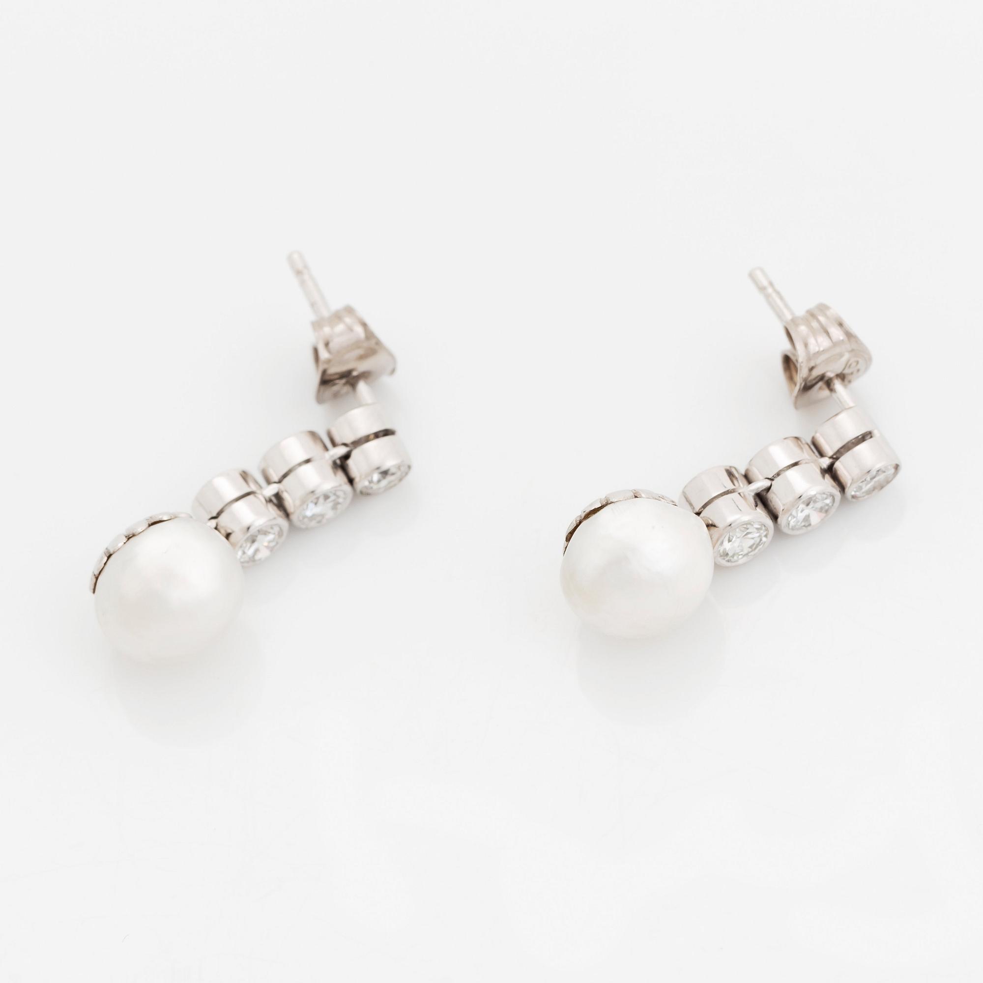 A pair of 18K white gold earrings set with pearls and round brilliant-cut diamonds.