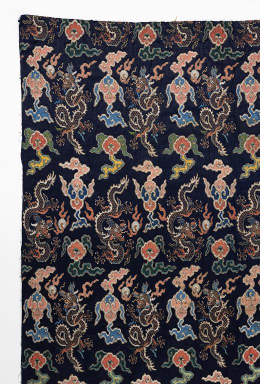 A set of three bolts of silk with 'five clawed dragons' against a midnight blue ground, Qing dynasty, 19th century.