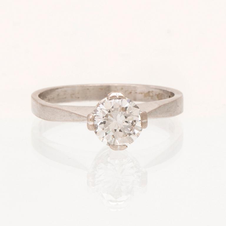 An 18K white gold solitaire ring set with a round brilliant cut diamond.