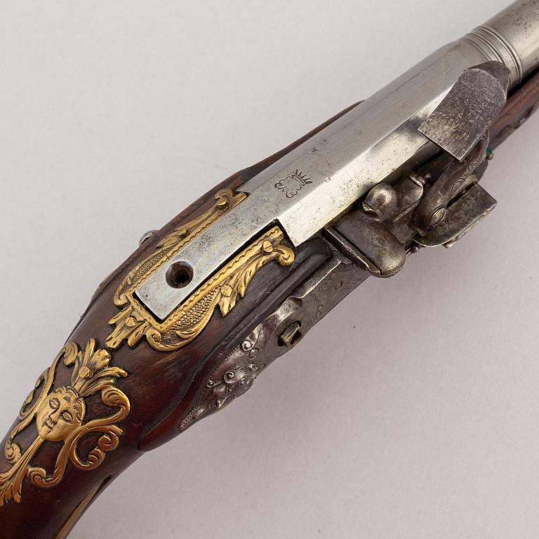 Two percussion and a flintlock pistol, 18th and 19th Century.