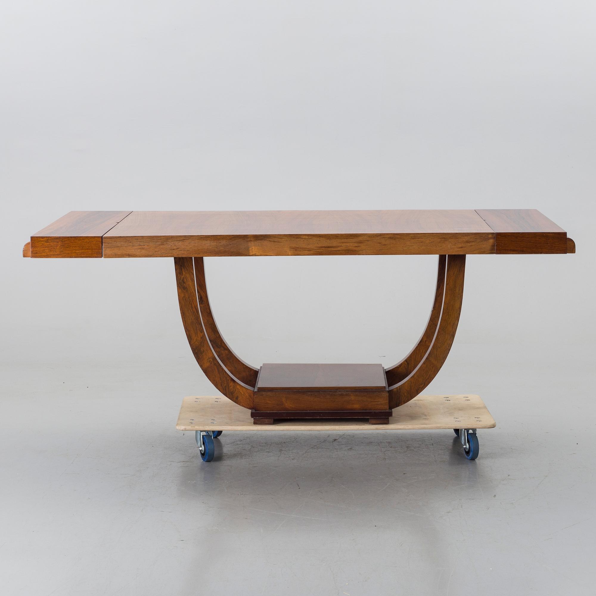 A french art deco dining table with extra boards.