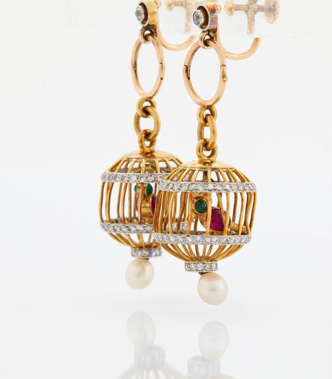 A pair of 18K gold birdcage earrings set with eight-cut diamonds, rubies and emeralds.