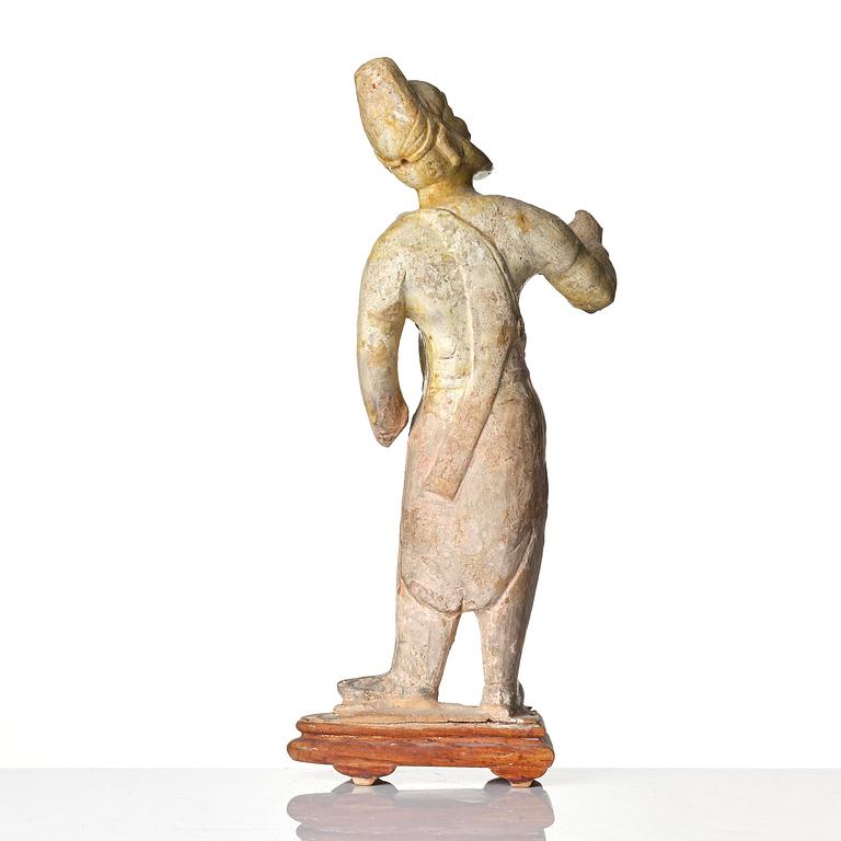 A yellow glazed potted figure of a groom, Tang dynasty (618-907).