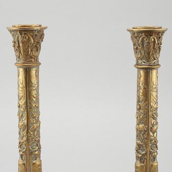 A pair of brass candlesticks from Elkingtons in Birmingham, 19th century.