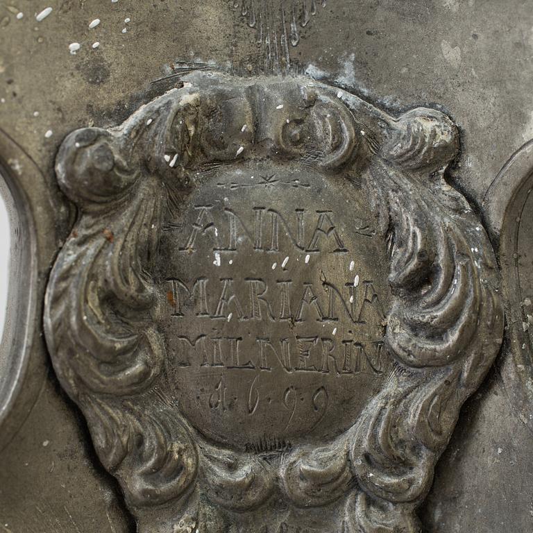 A pair of baroque pewter candlesticks, engraved date 1699.