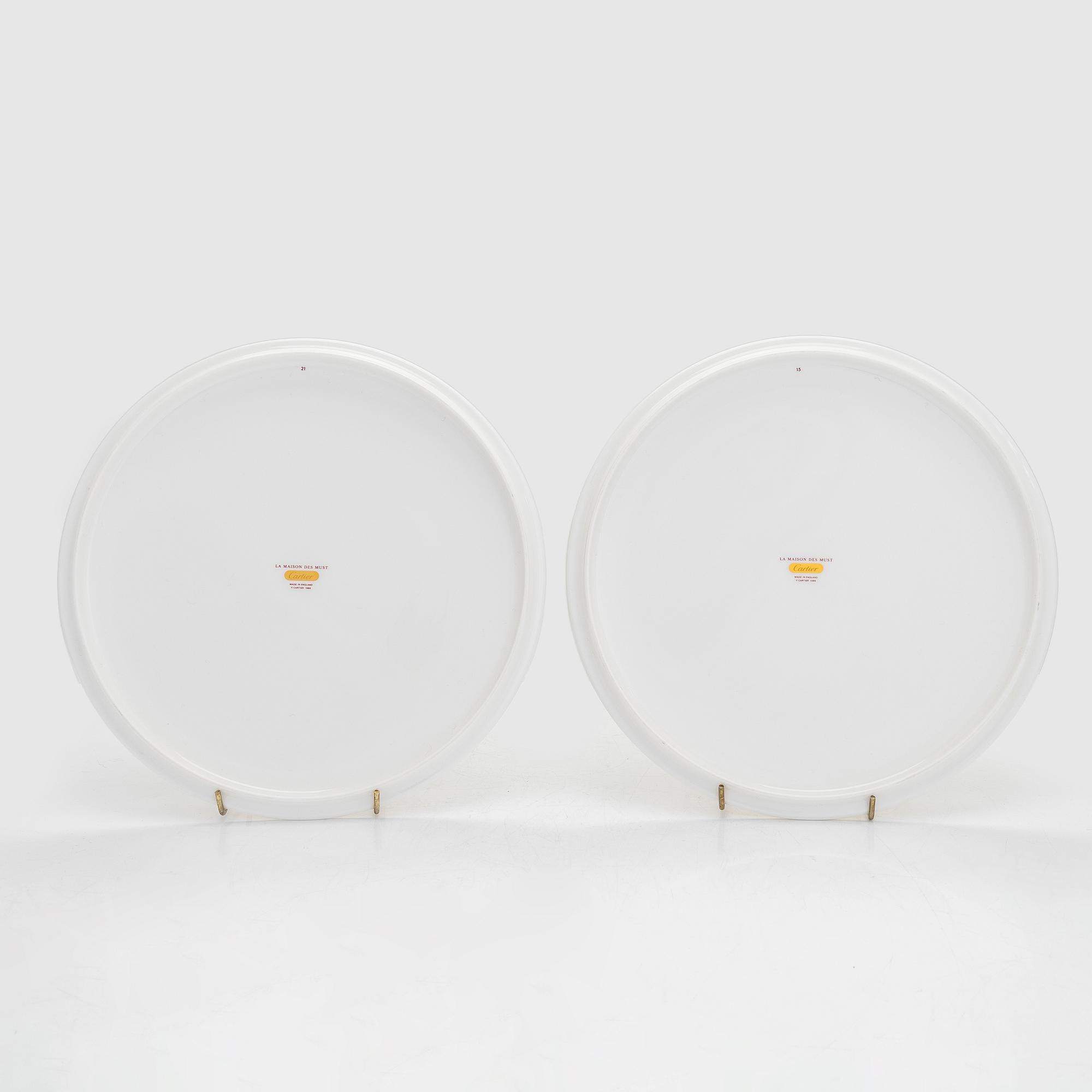 Cartier, two 'La Maison des Must' porcelain cake dishes.