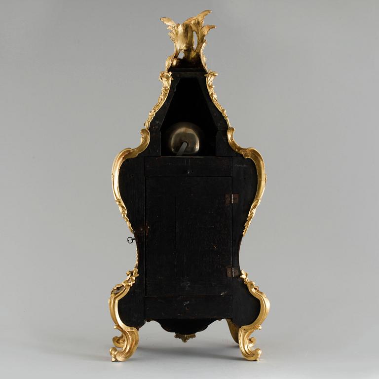 A 19th century mantle clock in the style of Louis XV.