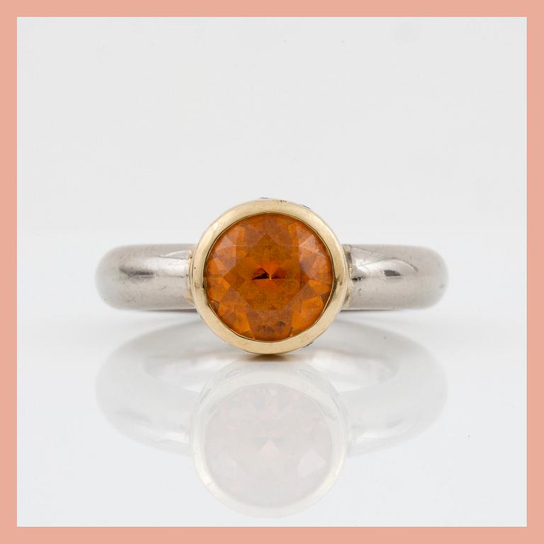 An orange spessartine garnet, ca 4.00 cts, and brilliant-cut diamond ring. Total carat weight of diamonds circa 0.12 ct.