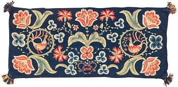 316. An embroidered carrige cushion, ca 108 x 48 cm, signed AMA, Scania, first half of the 19th century.