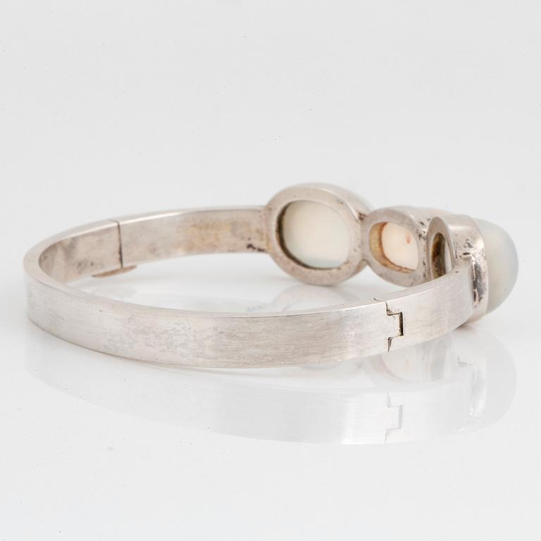 Wiwen Nilsson, a sterling silver bangle with three cabochon cut moonstones, Lund, Sweden 1938.