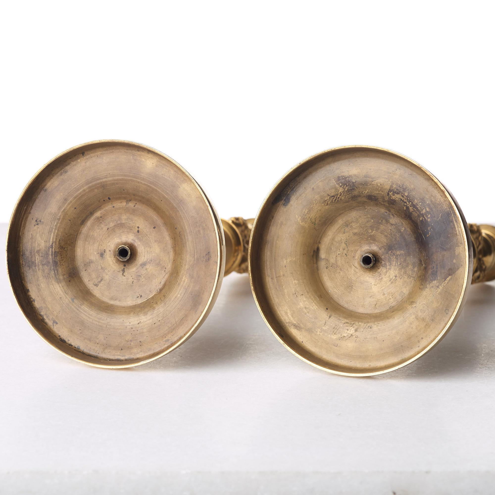 A pair of French Empire early 19th century gilt bronze candlesticks.