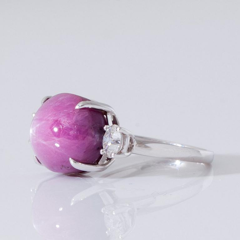 A cabochon cut star ruby and brilliant cut diamond ring. Diamonds total carat weight 1.20 ct.