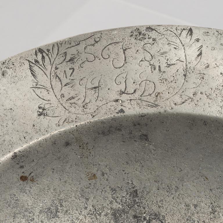 A large pewter charger, Sweden, dated 1701.