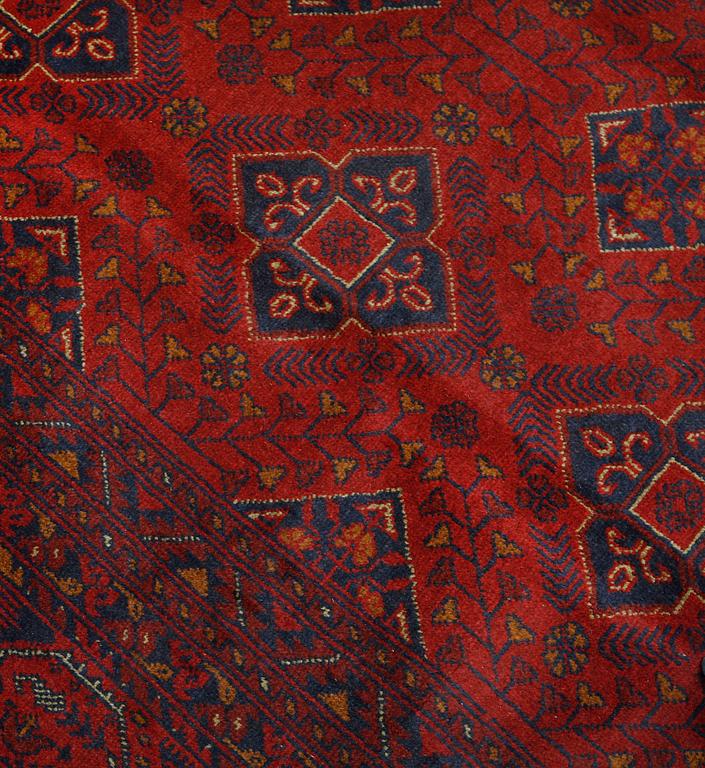 An Afghan carpet, 343 x 243 cm.