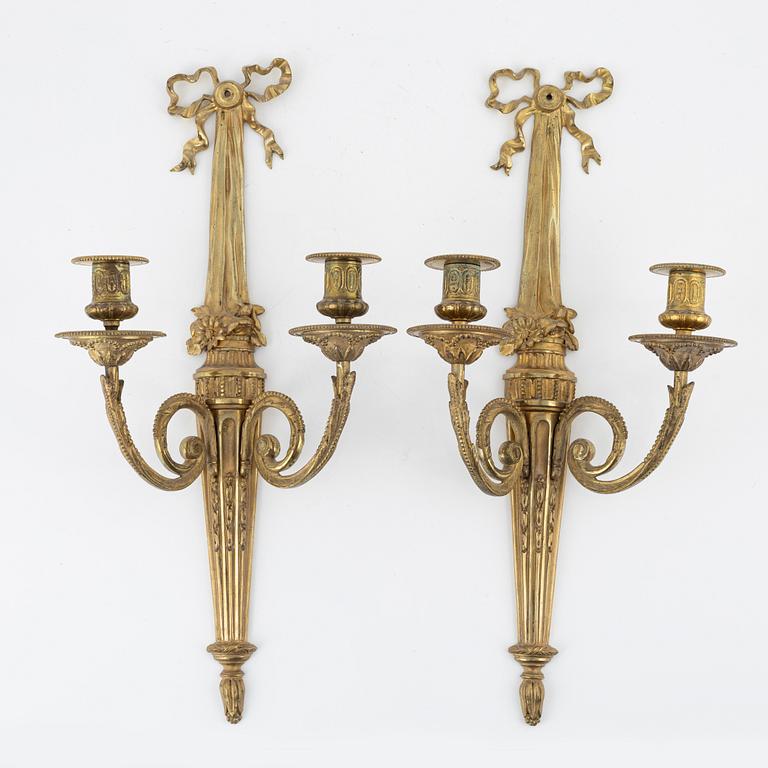 A pair of gilt brass wall sconces, Louis XVI-style, early 20th century.