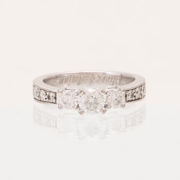 An 18K white gold ring set with round brilliant cut diamonds.