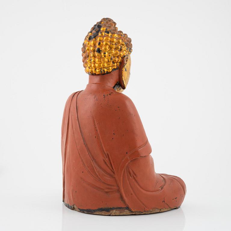 A large Vietnamese gilt and lacquered wooden buddha, circa 1900.