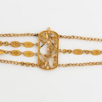 An 18K gold bracelet.