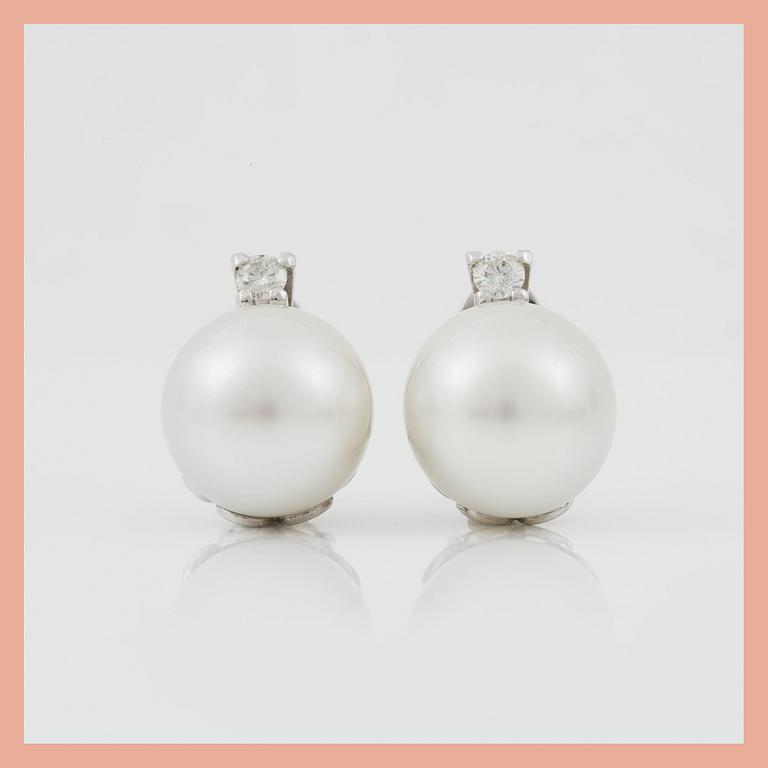 A pair of cultured South sea pearl and diamond earrings. Total carat weight of diamonds circa 0.35 ct.