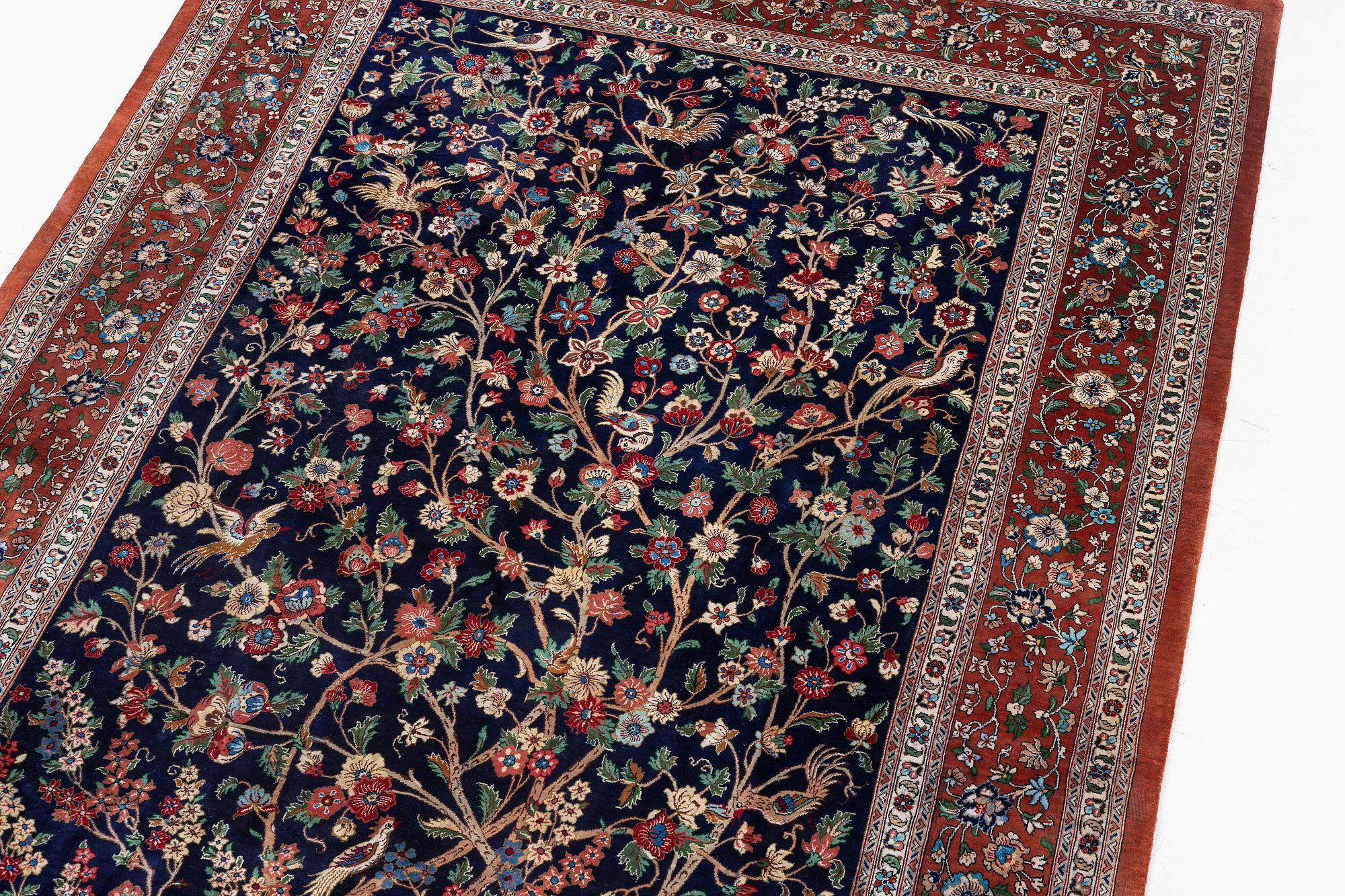 A signed pictoral silk Qum rug, c. 203 x 127 cm.