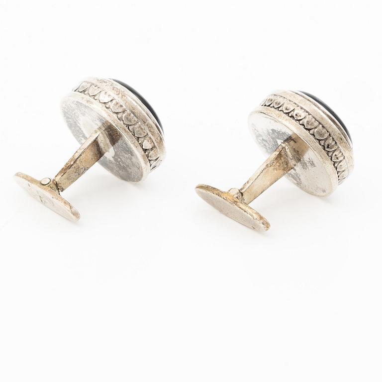 Cufflinks, a pair in silver with cabochon-cut stones.