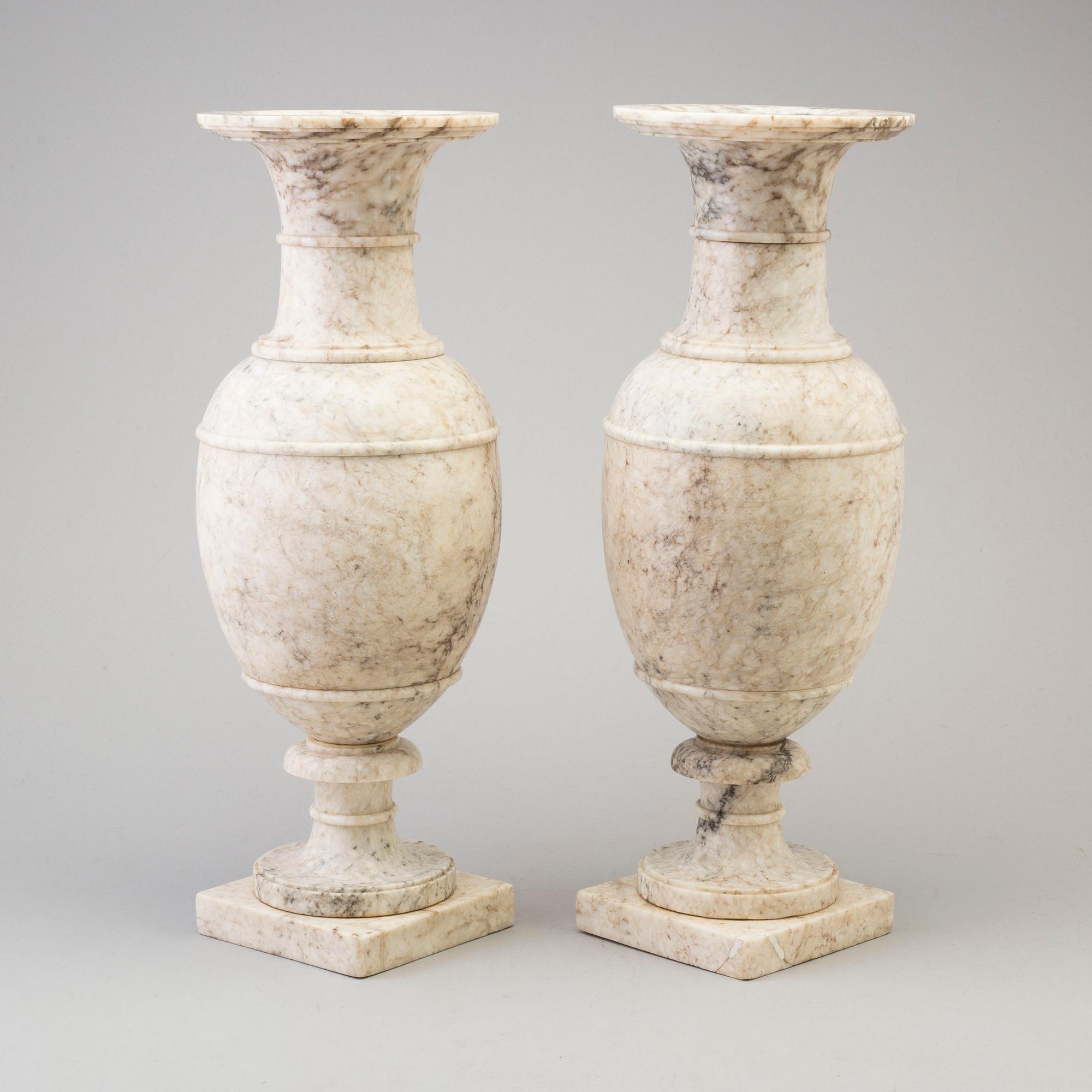 A pair of marble urns, circa 1900.