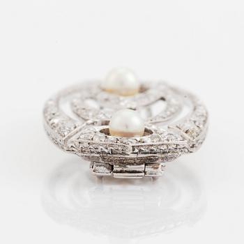 A silver brooch set with old- and rose-cut diamonds and pearls.