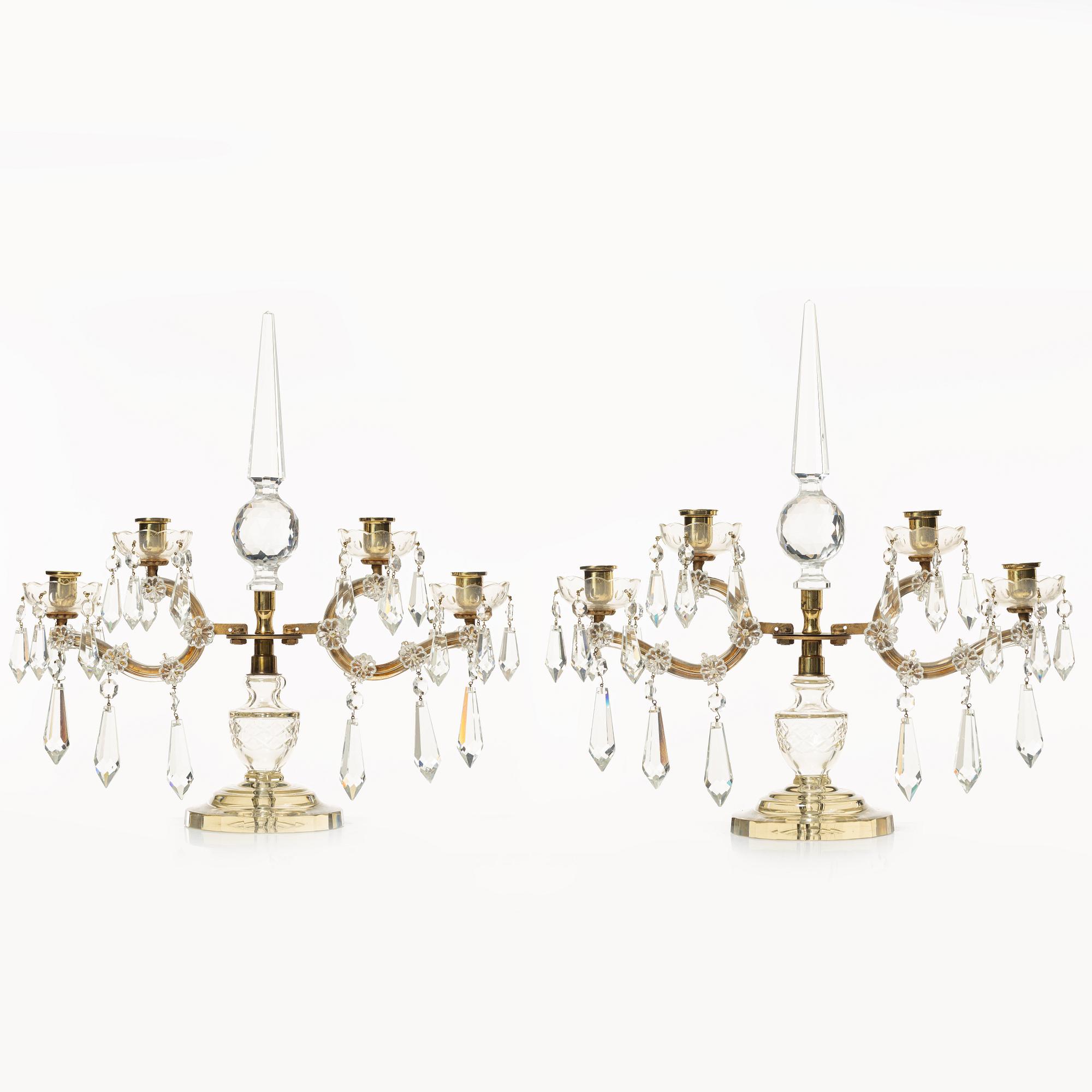 A pair of brass and glass canelabras, first half of the 20th century.