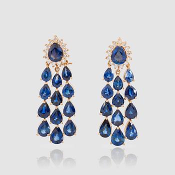1384. A pair of pear-shaped sapphire and brilliant-cut diamond earrings. Total carat weight circa 0.75 ct.