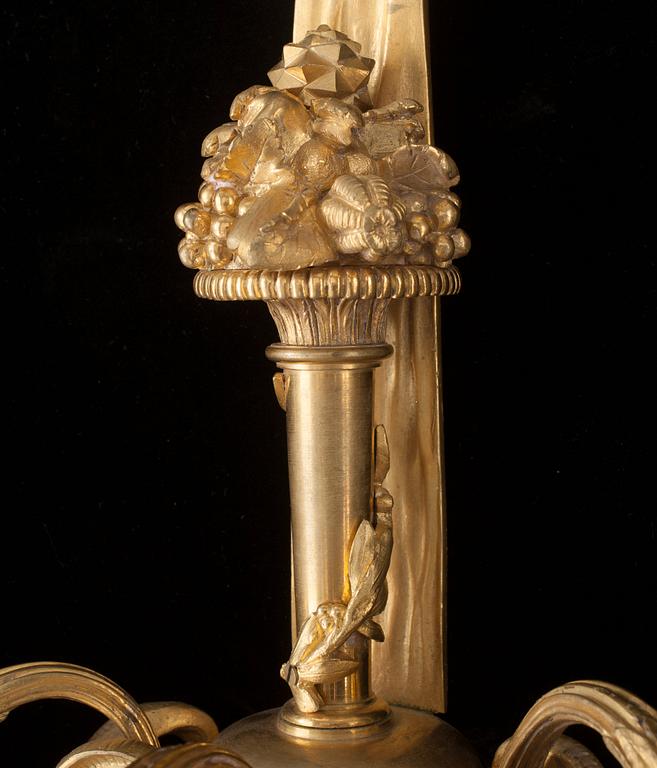 A pair of Louis XVI-style 19th century gilt bronze three-light wall-lights.