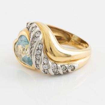 18K gold and heart shaped blue topaz and white stones.