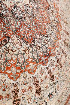 An Oriental silk rug, diameter 256 cm.