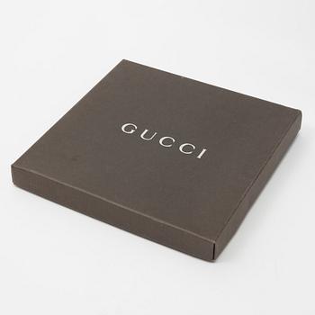 Gucci, a silk scarf.