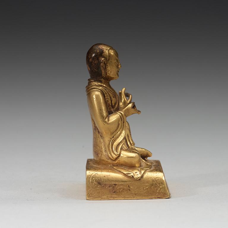 A small gilt-bronze seated Buddhist lama, Tibet, 20th Century.