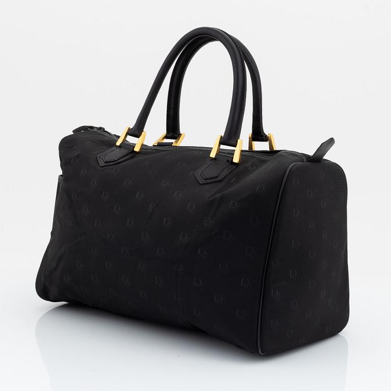 Christian Dior, a black canvas weekend bag.