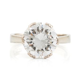 572. An 18K white gold ring set with a round brilliant-cut diamond.