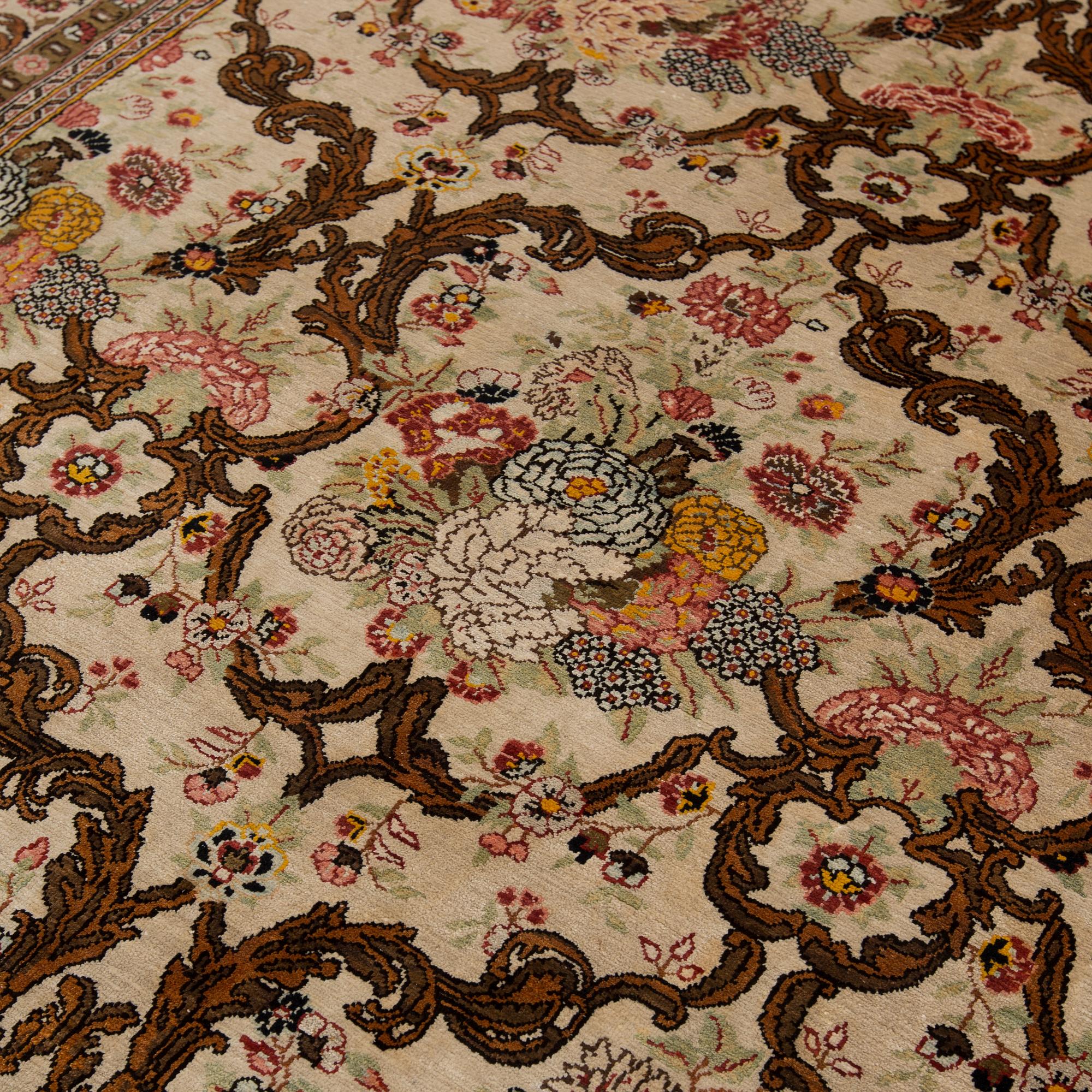 A silk Qum rug, around 220 x 134 cm.